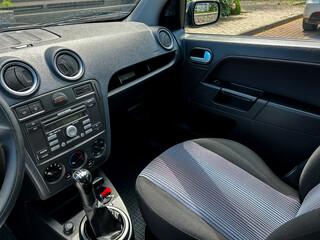 This car interior features a stylish console, comfy seats, and a hightech dashboard, all...