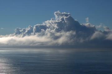 Horizon's Breath Rolling marine clouds meeting the silent ocean edge.