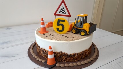 A construction themed birthday cake with a yellow loader and traffic cones decoration on a white table on transparent background silhouette