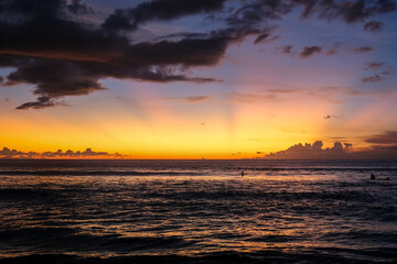 Beautiful and exotic sunset at Kuta Beach, Bali, Indonesia, captured from the shoreline. The golden sky reflects on the waves, attracting many tourists to witness this must-see view in Bali.