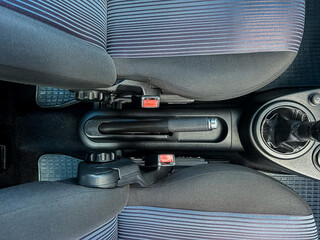 A detailed interior view of a car showcasing the center console along with the front seats, which...