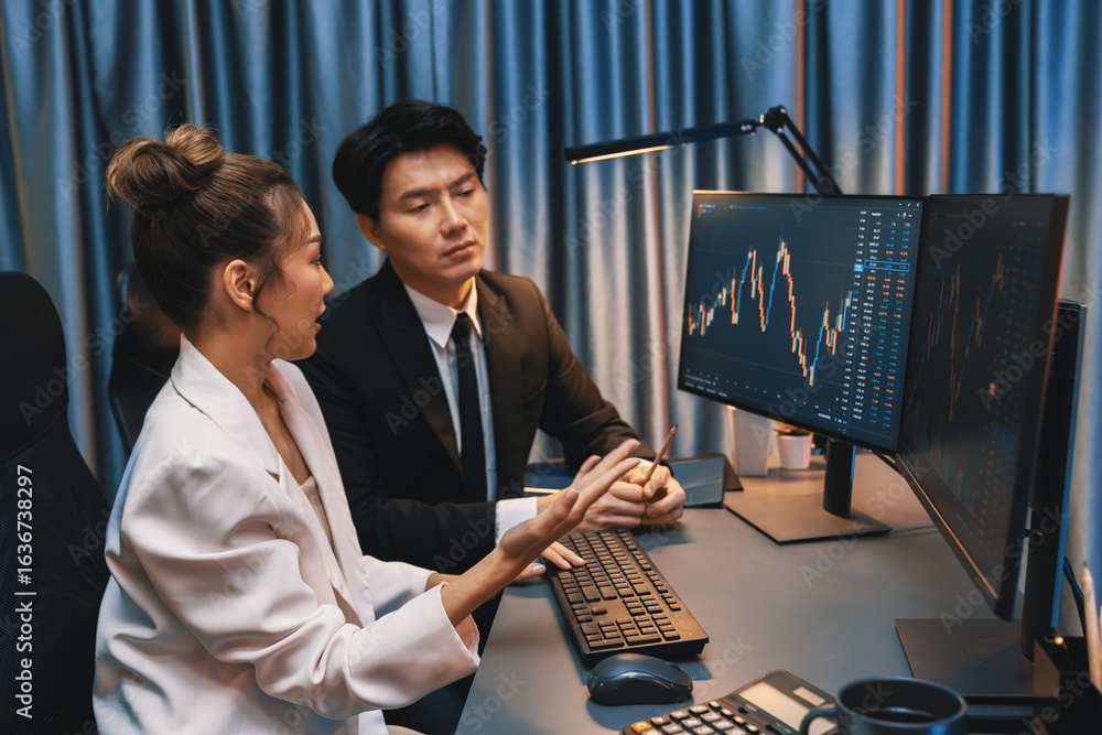 Poster smiling asian business traders pointing to dynamic stock exchange data screen profit value online we