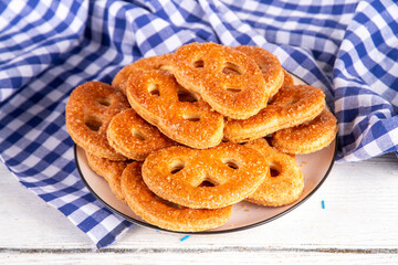 Sweet sugary pretzel cookies on Oktoberfest decorated background. Homemade homemade biscuit sweet cookies with sugar sprinkles, on a wooden background