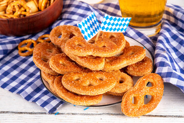 Sweet sugary pretzel cookies on Oktoberfest decorated background. Homemade homemade biscuit sweet cookies with sugar sprinkles, on a wooden background