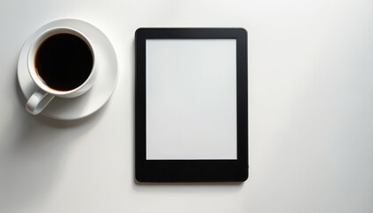 Fototapeta premium Modern e-reader device with blank screen placed on clean white table next to cup of hot coffee. Minimalist composition highlights digital reading technology, simple beverage break. Perfect for