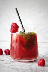 red drink, raspberry kombucha in glass with fresh berries on a white background