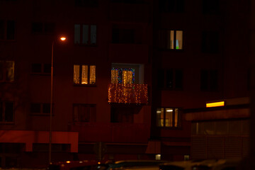 A blurry image of a building is visible during the night, with soft shades of brown and orange illuminating the scene