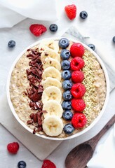 Vegan Porridge bowl with fresh fruits on a white plate and white background