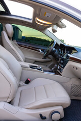 The luxurious interior of a modern vehicle showcases exquisite beige leather seats that provide comfort and elegance, along with advanced dashboard features that enhance the driving experience