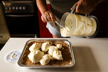 Woman making Tiramisu dessert in the kitchen