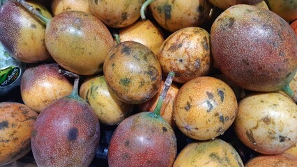 Fresh of Markisa konyal or passion fruits for sale at supermarket in Indonesia