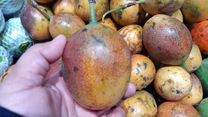 Fresh of Markisa konyal or passion fruits for sale at supermarket in Indonesia