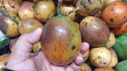 Fresh of Markisa konyal or passion fruits for sale at supermarket in Indonesia