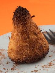 Golden Brown Coconut Macaroon on White Plate