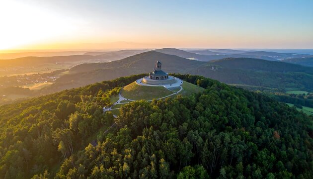 Panoramic sunrise view of a hilltop memorial