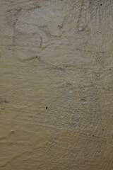 Textured yellow painted wall with scratches and marks