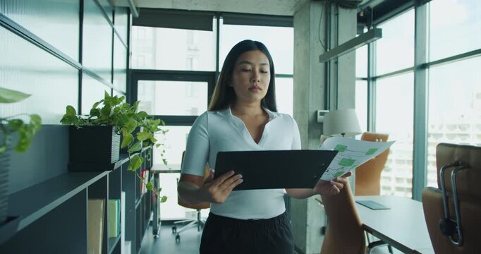 A dedicated professional reviews and analyzes important documents in an office, ensuring details meet standards