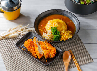 Japanese Curry Rice with Crispy Chicken Cutlet, Fluffy Omelet, corn, and broccoli in bowl side view of taiwan food