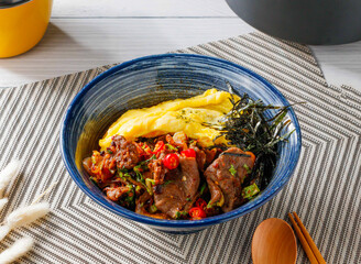 Spicy Beef Rice Bowl with Kimchi, Soft Omelet, and Shredded Seaweed in bowl side view of taiwan food