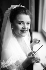 Bride applying mascara before wedding. Close-up with mirror reflection captures tenderness,...