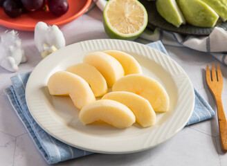 Ripe and Juicy Apple Slices on a Plate side view of Refreshing Fruit Snack