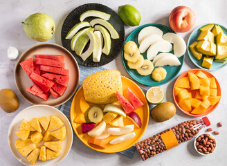 Assortment of Fresh Fruits, sliced Asian pear, Juicy Apple Slices, Avocado Chunks, Peanuts in Bottle, Golden Kiwis, Guava Slices, Diced Mango, Colorful Fresh Mixed Fruit Platter, Pineapple Chunks