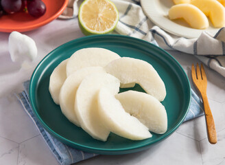 Fresh sliced Asian pear on a plate side view of delicious fruit snack