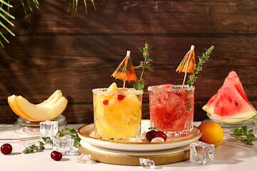 Mojito with melon, mint, watermelon, ice with tequila, vodka or soda water on elegant background,...