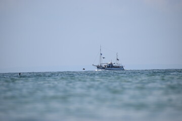 The photo shows a ship with tourists sailing in the sea.