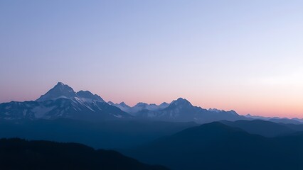 Fototapeta premium Majestic mountain range during blue hour, with a soft gradient of twilight colors.