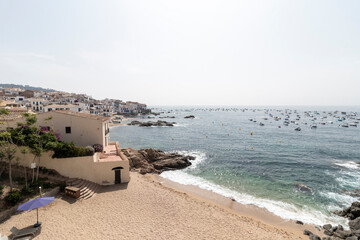 Obraz premium Calella de palafrugell beach and boats on sunny day in spain