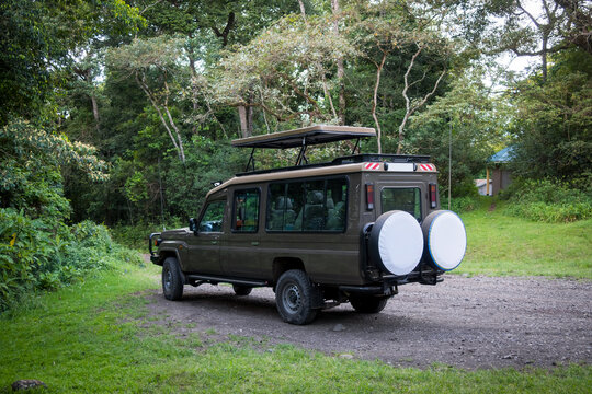Large safari four wheel drive vehicle in the Arusha National park in rainforest in Tanzania, Africa.
