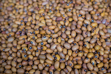 Heap of organic yellow African beans close up view.