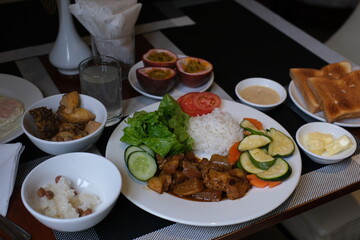white rice with tomatoes and herbs Beef steak, rice and vegetable power bowl. Healthy balanced food concept. On a dark background, top view . High quality photo