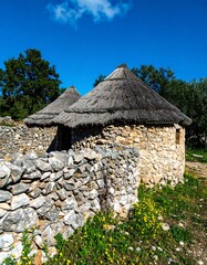 Ancient stone huts under thatched roofs