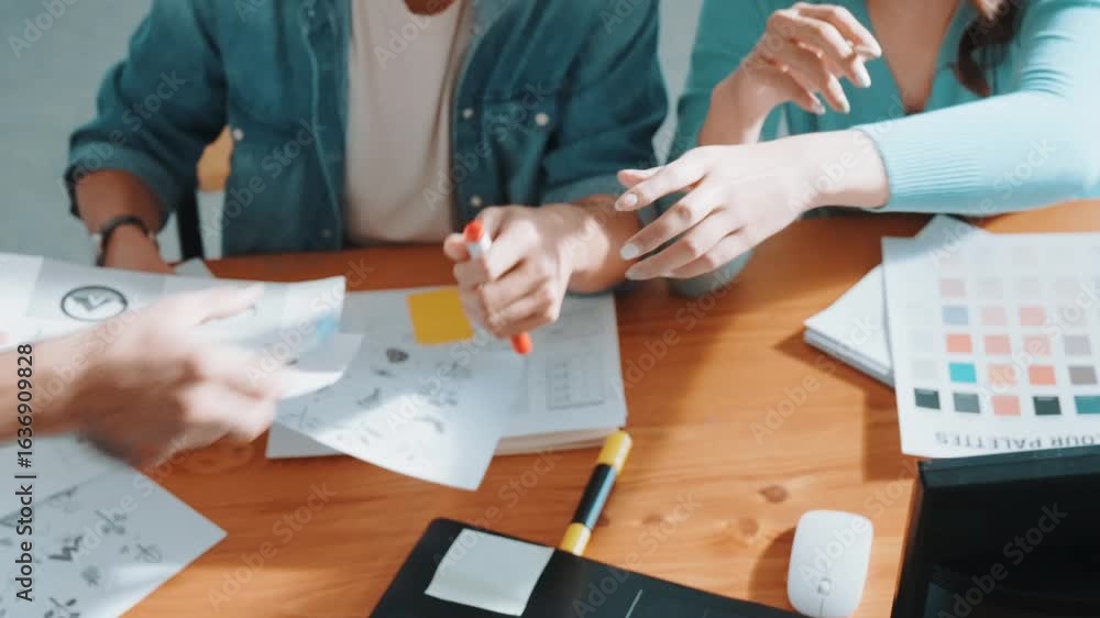 Aufkleber close up of smart business team hands looking at color palette at table while throw paper in the air