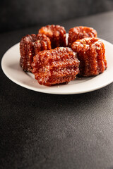Canneles sweet dessert french cuisine sweets fresh delicious gourmet food background on the table rustic food top view copy space