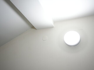 Bright wall-mounted LED light fixture glowing in a modern minimalist interior

