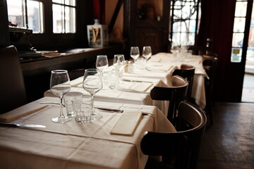 Elegant Dining Table Setting in Cozy Restaurant with Natural Light and Classic Ambiance