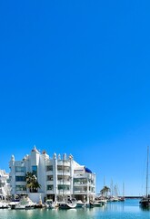  View of white fairytale houses and clear blue sky in Benalm&aacute;dena Pueblo, a charming town in Andalusia, Spain.