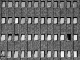 Symmetry and Patterns in Urban Architecture Featuring a Brick Building with Uniform Rectangular...