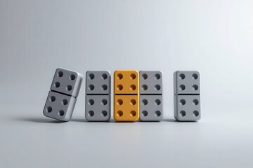 Domino effect: A row of dominoes with one uniquely colored domino stands out, one is falling down.