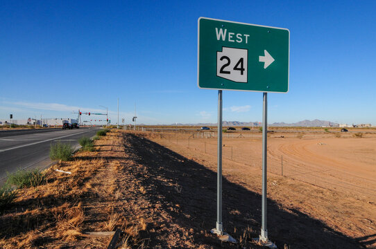 Highway sign for State Route 24 Gateway Freeway westbound at the Maricopa County and Pinal County border, representing regional transportation infrastructure