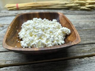 Homemade traditional cottage cheese organic dairy product in wooden bowl