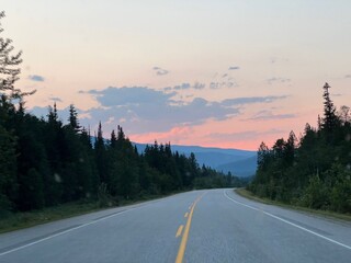 Naklejka premium Sunset over road in the mountains