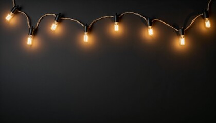 Happy traditional shining diwali. String lights with warm bulbs on dark background  