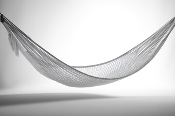 Suspended woven hammock in grayscale tones, casting a soft shadow, against a clean, minimalist, light backdrop.