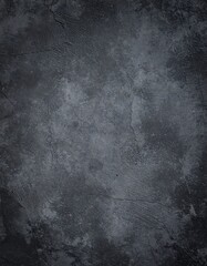 Dark, textured surface with varied shades of gray