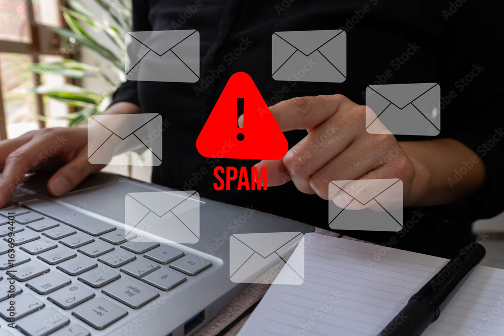 Poster email risk detection. close-up of a professional's hands using a computer pointing to a warning sign