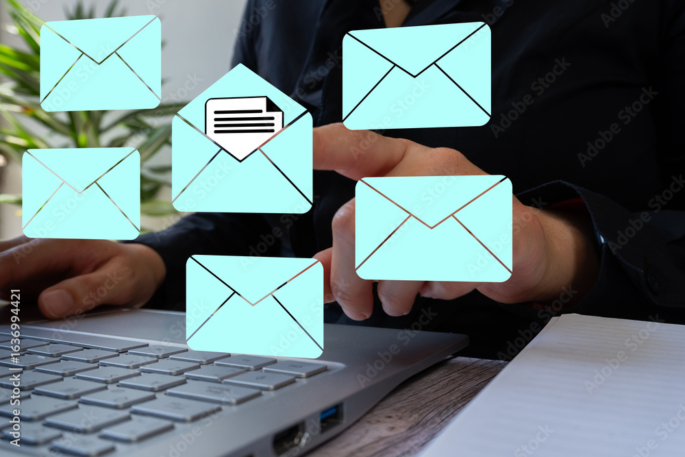 Poster reading email. close-up of a professional's hands using a computer, pointing to several floating env